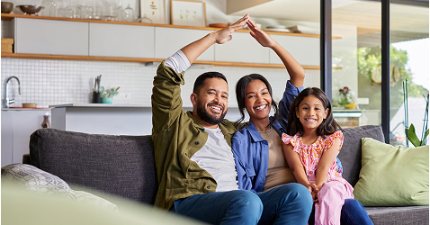 Smiling family celebrating new home purchase with Eagle Peak Conveyancing assistance