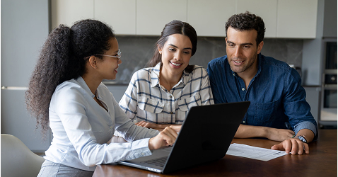 Eagle Peak Conveyancing professional discussing property sale documents with clients at desk.