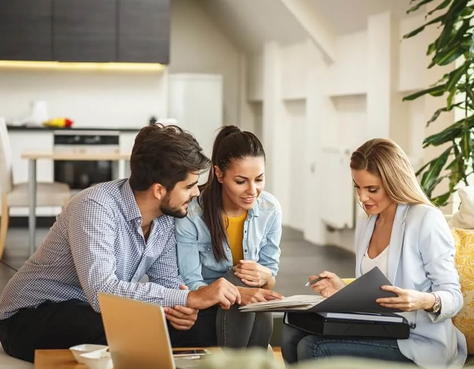 Eagle Peak professional conveyancer in Dandenong helping a smiling couple review documents for a smooth property transaction.