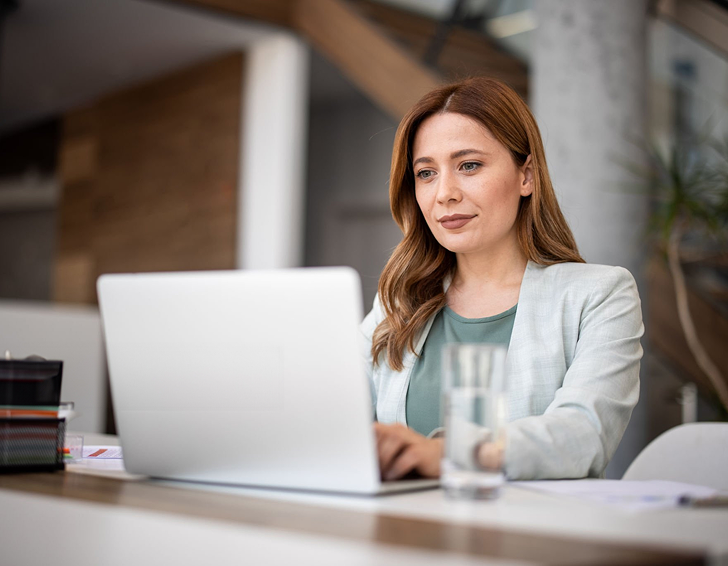 Melbourne-based female conveyancer focused on laptop work, delivering Eagle Peak Conveyancing services.
