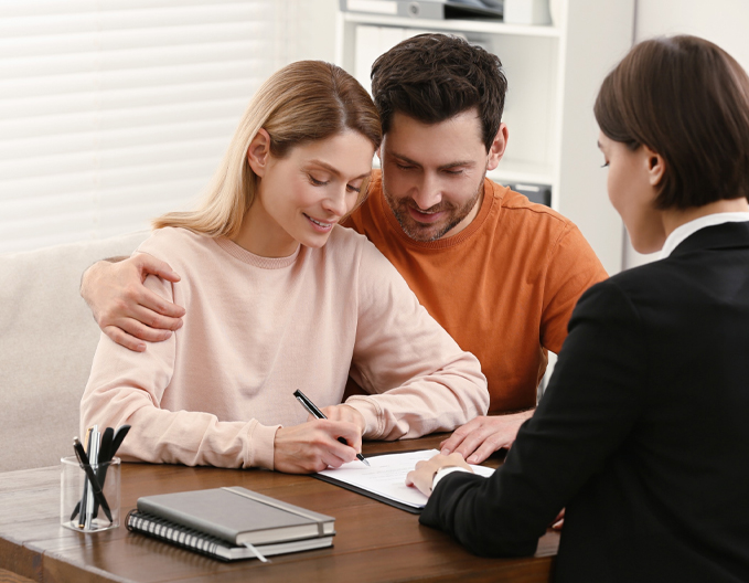 Eagle Peak conveyancer in Caroline Springs guiding a trusting couple as they sign property settlement documents.