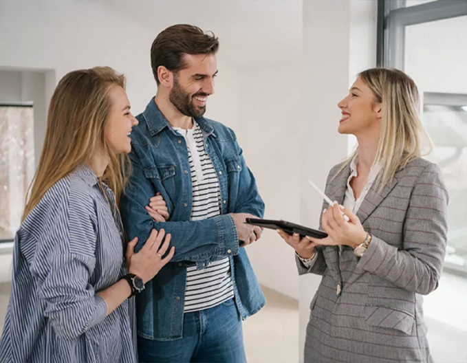 Eagle Peak conveyancer in Point Cook consulting with a smiling couple about their first home or property transfer.